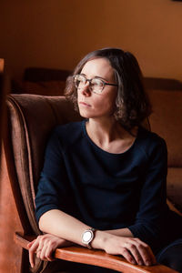 Young woman sitting on sofa