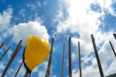 Low angle view of yellow metal structure against sky