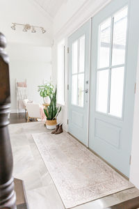 Entry way with blue door and ladies rainbows