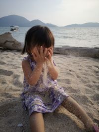 Rear view of girl on beach