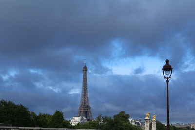 Low angle view of tower against cloudy sky