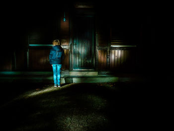 Woman standing in the dark