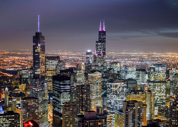 Aerial view of city lit up at night