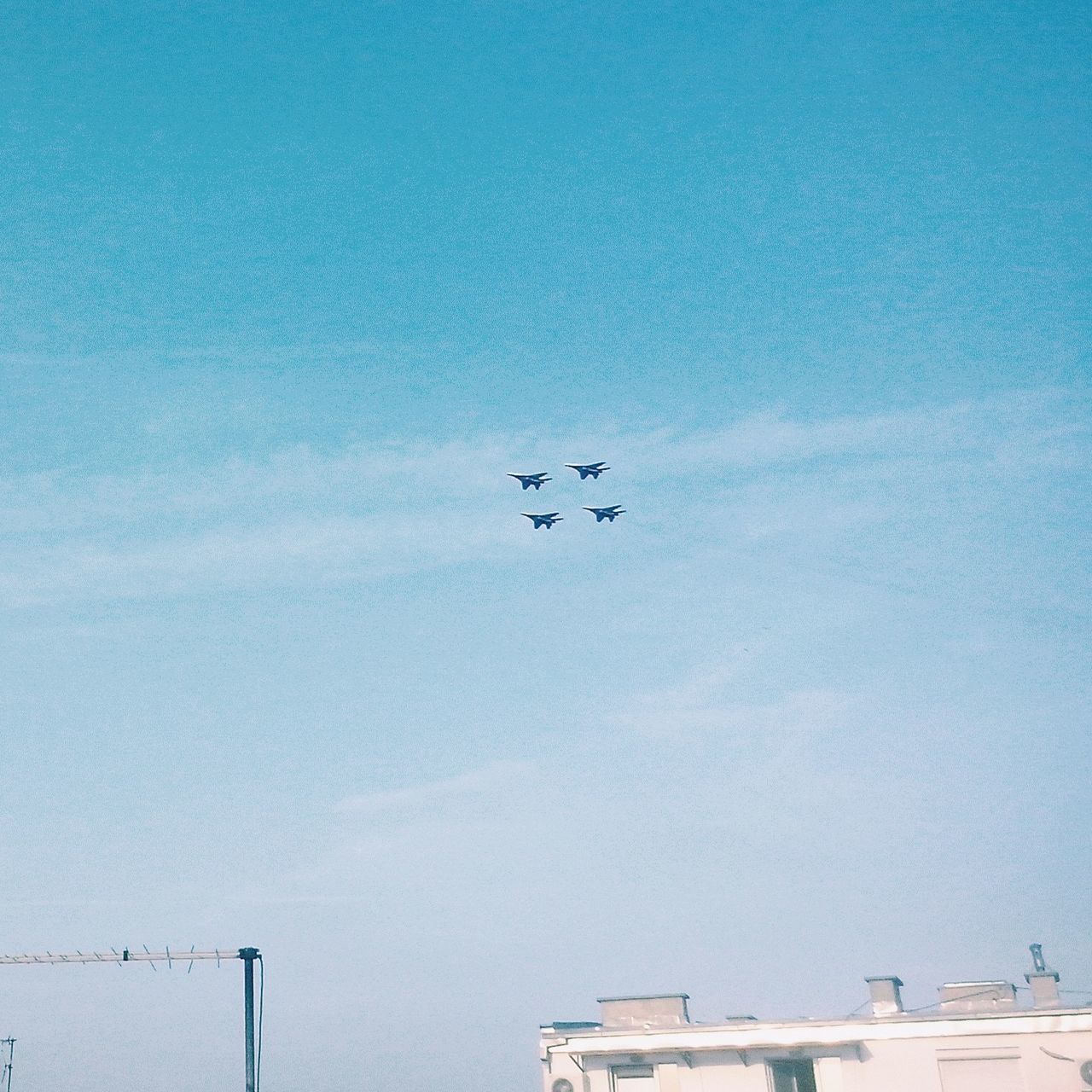 flying, blue, low angle view, copy space, clear sky, mid-air, transportation, built structure, day, bird, air vehicle, outdoors, mode of transport, building exterior, sky, architecture, nature, airplane, no people, high angle view