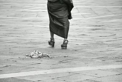 Low section of woman walking on footpath