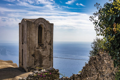 Castle by sea against sky