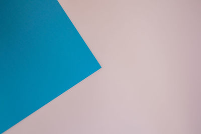 High angle view of paper against blue background