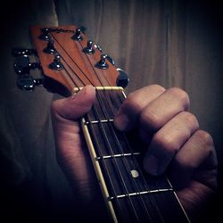 Cropped image of person playing guitar