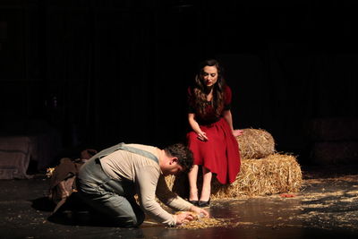 Young couple sitting on floor at night