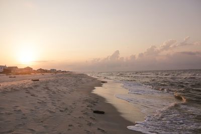 Scenic view of beach against sky during sunset