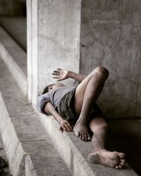 Man sleeping on concrete floor