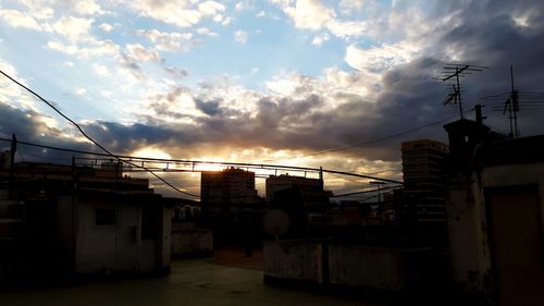 Low angle view of silhouette buildings against sky during sunset