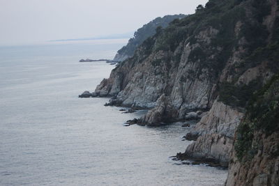 High angle view of rock formations by sea