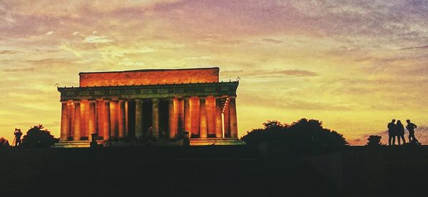 Built structure against sky at sunset