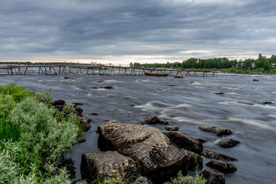 River flowing against dramatic sky