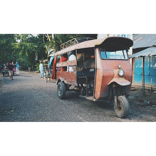 transportation, mode of transport, transfer print, land vehicle, auto post production filter, car, clear sky, street, stationary, road, outdoors, day, building exterior, built structure, travel, architecture, sky, parked, sunlight, abandoned