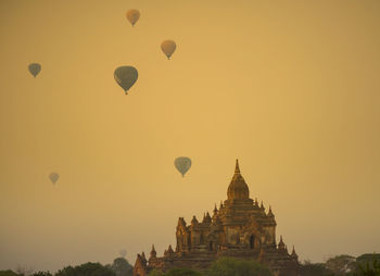 Hot air balloons against sky during sunset