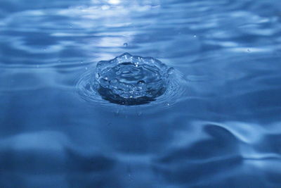 High angle view of drop falling on water