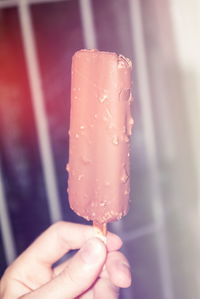 Close-up of hand holding ice cream cone