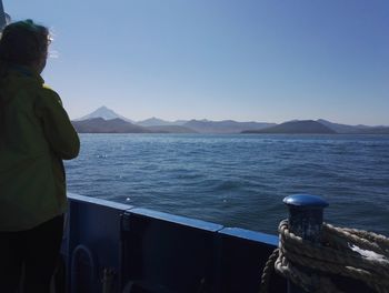 Rear view of woman looking at sea against sky