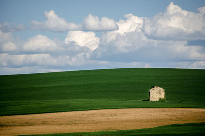 Scenic view of farm against sky