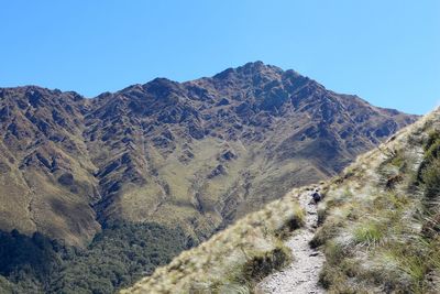 Scenic view of mountains against clear blue sky