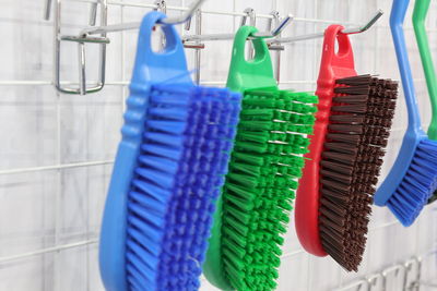 Close-up of multi colored umbrellas hanging in rack