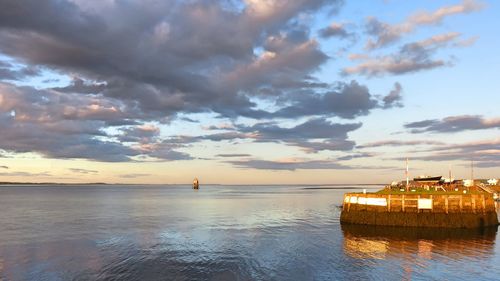 Scenic view of sea against sky at sunset