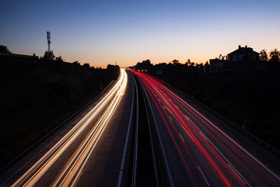 High angle view of light trails on highway at dusk
