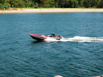 Man riding boat on sea