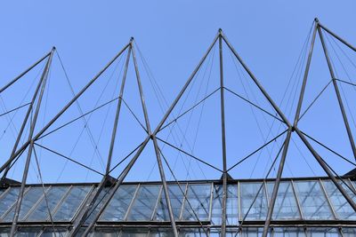 Low angle view of bridge against clear blue sky