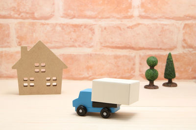 Close-up of stuffed toy against wall in house