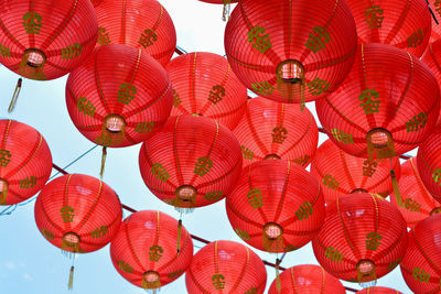 Low angle view of lanterns hanging against sky