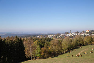 High angle view of townscape against clear blue sky