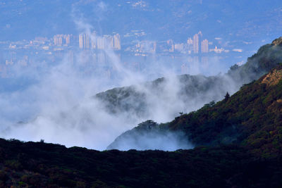 Scenic view of waterfall against sky