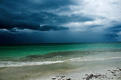 Scenic view of sea against storm clouds