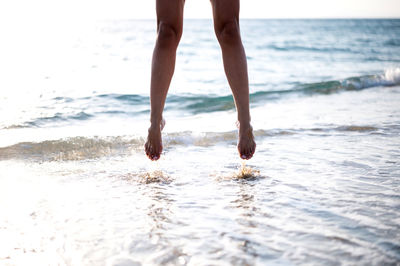 Low section of person standing on beach