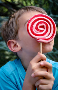 Close-up of boy holding lollipop