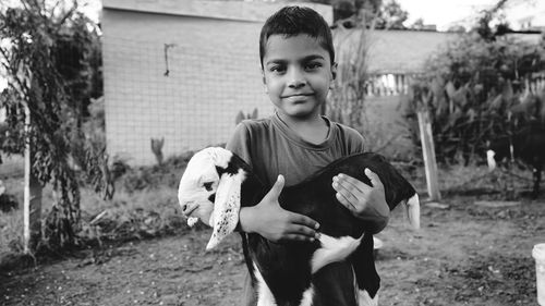 Portrait of boy standing outdoors