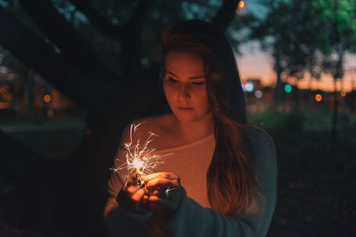 Young woman using smart phone at night