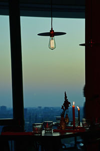 Low angle view of illuminated electric lamp on table at restaurant