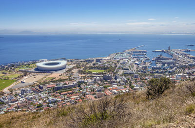 High angle view of buildings and sea against sky