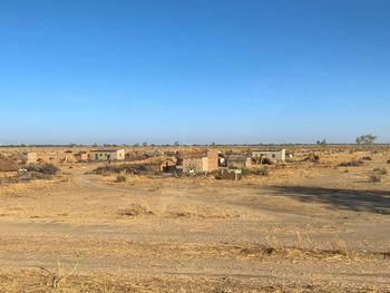 Built structure on land against clear blue sky