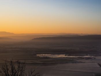 Scenic view of landscape against sky during sunset