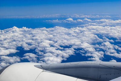 Aerial view of cloudscape over airplane wing