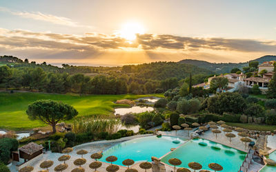 Scenic view of swimming pool against sky during sunset