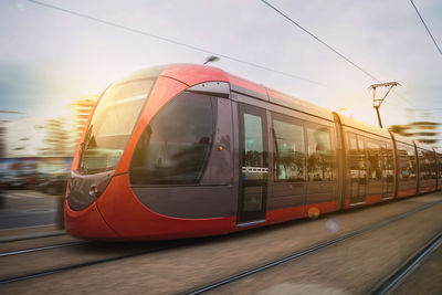 Tram against sky during sunset