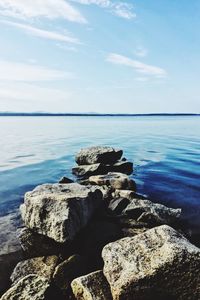 Rocks on beach against sky
