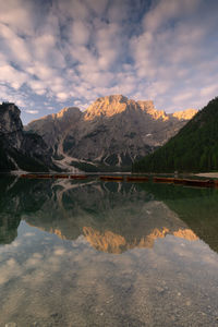 Scenic view of lake by mountains against sky