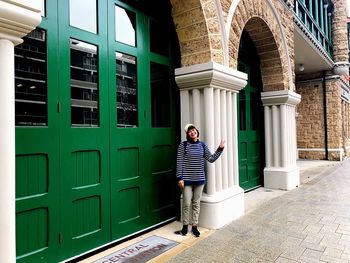 Full length of man standing against building